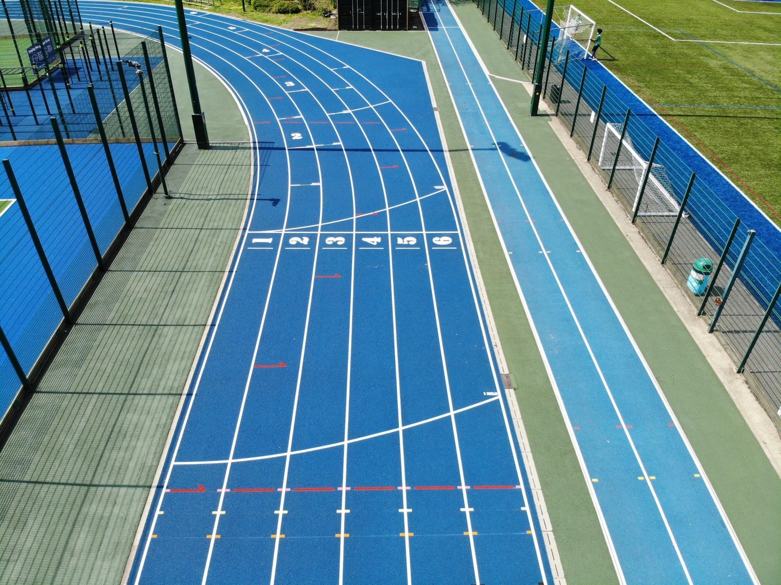 The athletics track surface also features an adjacent sprint straight installed for Westminster City Council in 2022.