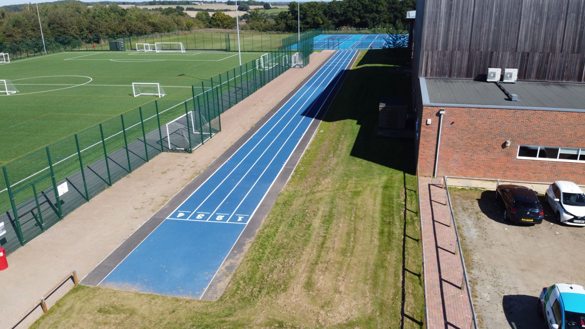 Installation of a new 110 ft four lane athletics track and MUGA for Sandringham school in Hertfordshire.
